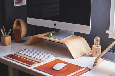 Compact corner office desk in a cosy home workspace, perfect for maximising small spaces in the UK.